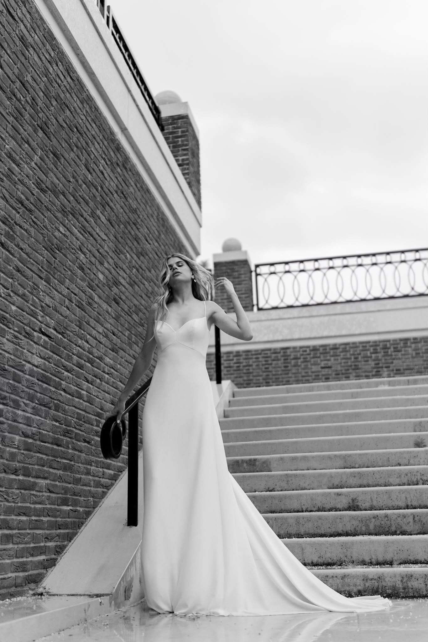 Black-and-white bridal portrait on a staircase