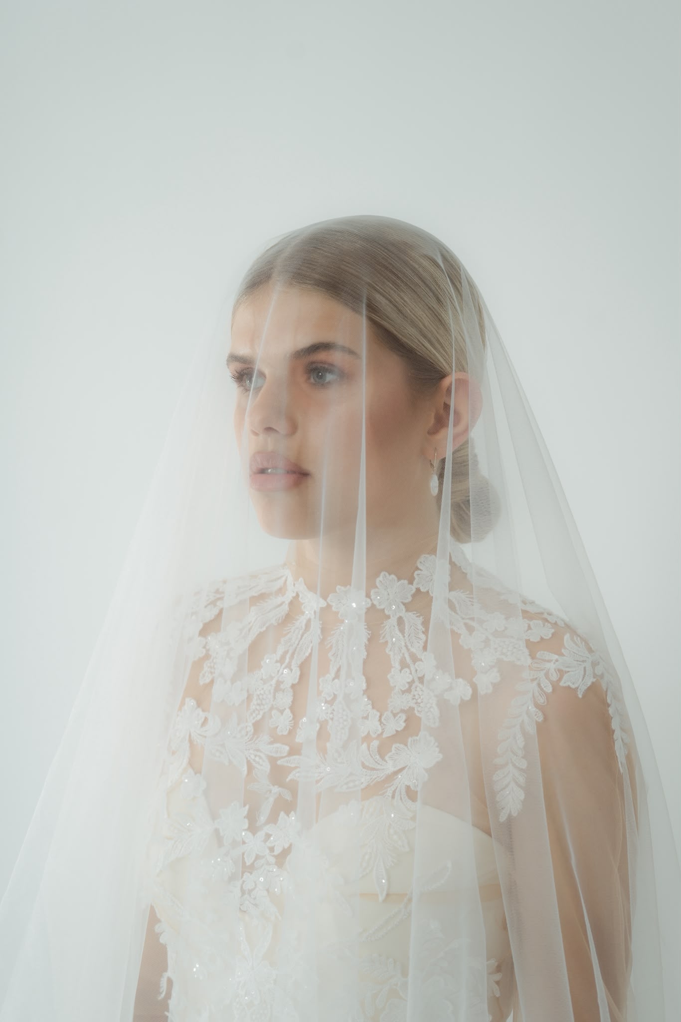 Bride with a sleek low bun beneath a veil