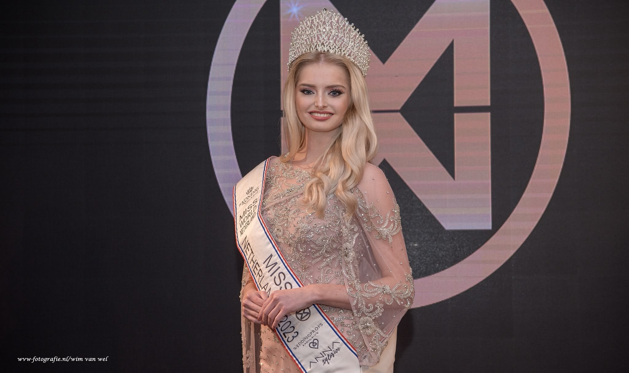 Beauty pageant contestant with long blonde hair and a crown